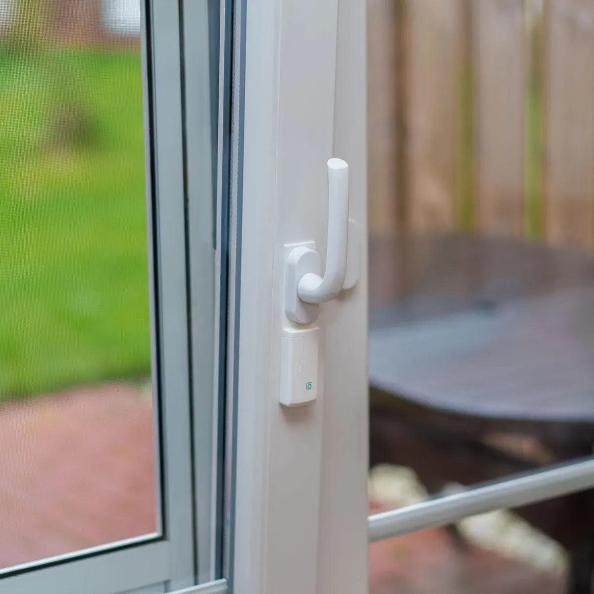 Homematic IP Fenstergriffsensor an einer weißen Terrassentür